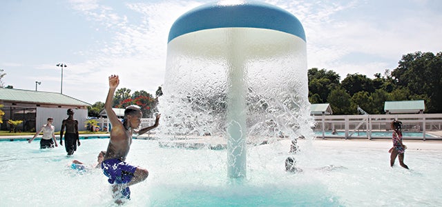 Marcus Barnett, 14, splashes past the fountain in the kid’s pool at Vicksburg City Pool. The fountain was repaired and opened Wednesday. The summer swim season for the pool ends Friday, but it will be open the next two weekends.