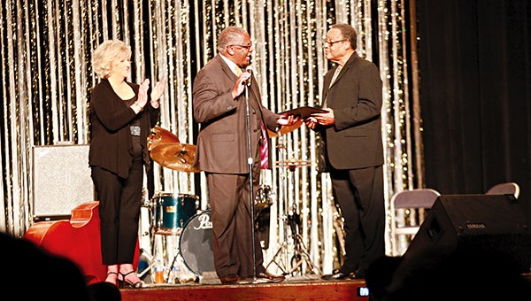 Shirley Waring, left, watches Sunday as Mayor George Flaggs Jr. presents Andy Hardwick a resolution from the city honoring him for his contributions to music during the Hank Jones memorial concert Sunday at Vicksburg City Auditorium. Hardwick, who is the last surviving member of the Red Tops, was the headliner during the concert honoring Jones, a Vicksburg-born jazz legend.