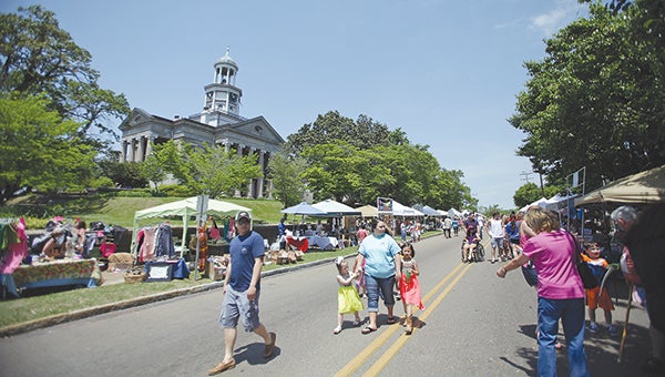 Festival-goers walk down Cherry Street during the Old Court House Museum Flea Market in April.