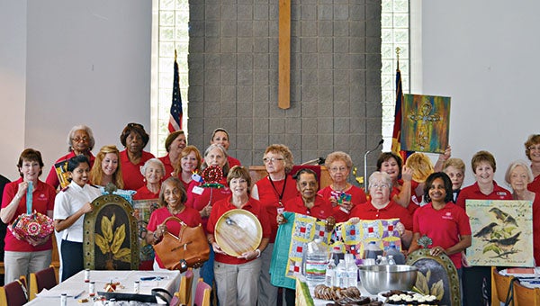 Women’s Auxiliary of The Salvation Army hold items that will be auctioned off at the Silent Auction on October 14.