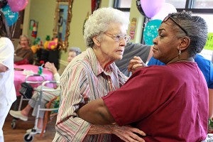 Heritage House Retirement Center resident Rona Averill, 80, dances with attendant Mattie Cole Friday afternoon during a luau-themed cookout. Heritage House had events all week celebrating National Assisted Living Week. (Justin Sellers/The Vicksburg Post)