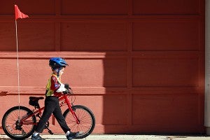 Carter Bobbitt walks his bike back to the parking lot on South Street Saturday morning after finishing the 5th annual Bricks and Spokes bicycle ride. (Justin Sellers/The Vicksburg Post)