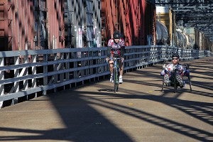 Cory Goss, right, representing Paralyzed Veterans of America Racing Team, rides Saturday morning on the Old U.S. 80 bridge during the 5th annual Bricks and Spokes bicycle ride. (Justin Sellers/The Vicksburg Post)