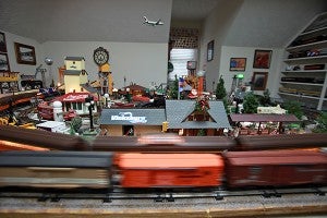Lionel model trains owned by Charles Riles travel around the track Thursday in his train room at his home. (Justin Sellers/The Vicksburg Post)