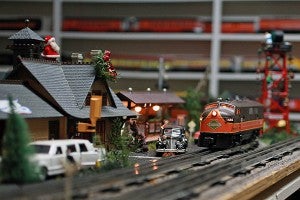 An Illinois Central-painted Lionel model train owned by Charles Riles travels around the track Thursday in his train room at his home. (Justin Sellers/The Vicksburg Post)