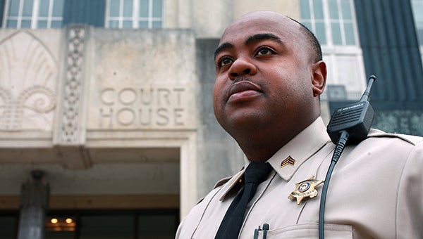 STANDING GUARD: Warren County Sheriff’s deputy Sgt. Maurice Brooks stands Wednesday outside the Warren County Courthouse. (Justin Sellers/The Vicksburg Post)