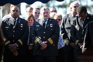 Vicksburg firefighters Darrell Flaggs, left, and Tim Love pay their respects with other firefighters Wednesday afternoon during the funeral of Vicksburg Fire Department Lt. Drue Randolph Wednesday at Greenlawn Gardens Cemetery. (Justin Sellers/The Vicksburg Post)