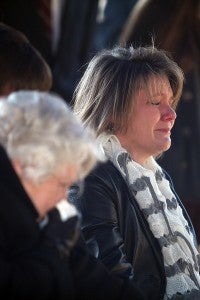 Perian Bufkin, the sister of Vicksburg Fire Department Lt. Drue Randolph, mourns with other family members Wednesday afternoon during his funeral at Greenlawn Gardens Cemetery. (Justin Sellers/The Vicksburg Post)