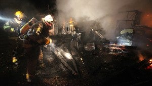 Warren County volunteer firefighters put out the smoldering remains of a structure fire Thursday night at a home at 5265 Mt. Alban Road belonging to Robert and Jennifer Hoover. No one was home at the time of the fire, but the home was a total loss, Warren County Fire Coordinator Jerry Briggs said. (Justin Sellers/The Vicksburg Post)