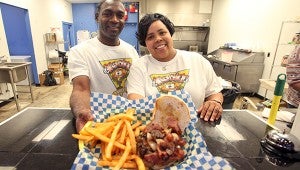Marvin and Shannon Atlas serve up a burger Thursday afternoon at Kooky Burgers, 3401 Halls Ferry Road. (Justin Sellers/The Vicksburg Post)