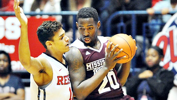 Mississippi State forward Gavin Ware (20) works against Ole Miss’ Sebastian Saiz on Wednesday. Ware scored 12 points, but Ole Miss won the game 79-73. (AP Photo/Oxford Eagle, Bruce Newman)