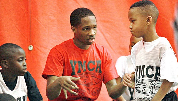 Dana II coach Darrick Carson talks to Jabari Judge, right, during a YMCA Junior Prep Boys league basketball game. (Ernest Bowker/The Vicksburg Post)