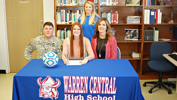 Warren Central soccer player Kylee Burke, center, signed with Meridian Community College last week. Burke is surround by her parents Darwin Burke, left, and Kristy Gullet, right, and Warren Central coach Viktoria Case. (Submitted to The Vicksburg Post)