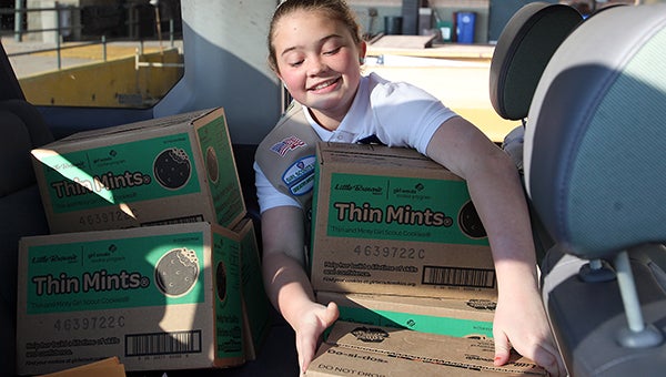 Troop 0420 Girl Scouts Emilee Bloodworth, 11, loads boxes of Girl Scout cookies into a vehicle Wednesday at the Vicksburg Convention Center in preparation of their cookie selling season. (Justin Sellers/The Vicksburg Post)