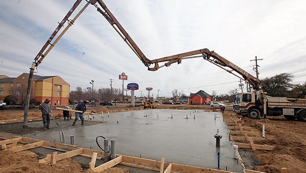 Vicksburg Ready Mix employees pour concrete Thursday afternoon for the foundation of the Dairy Queen being constructed next to Kroger. The store is expected to open sometime in early or mid-May, owner David Johnson said. (Justin Sellers/The Vicksburg Post)