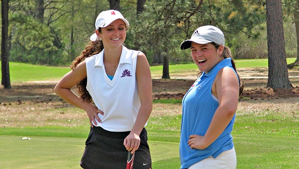 St. Aloysius’ Laura Phillips, left, and Warren Central’s Karley Whittington share a laugh on the seventh green during Monday’s St. Aloysius Girls Invitational at Clear Creek Golf Course. Whittington was the medalist and Phillips shots a 78 to help St. Al win the team title. (Ernest Bowker/The Vicksburg Post)