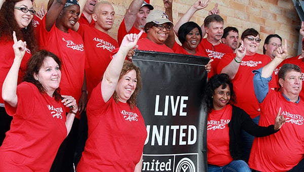 DAY OF CARING: Ameristar employees pose for a picture at the Vicksburg Mall Thursday morning before heading to a work site during the United Way of West Central Mississippi's annual Day of Caring. (Justin Sellers/The Vicksburg Post)