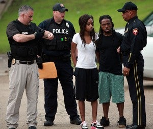 Vicksburg police officers talk to Tennesha Burns and Xavier Floyd after being arrested Friday morning at 1900 Baldwin Ferry Road, Apt. 9H. A joint operation called "Operation Long Time Coming," spearheaded by VPD and the Mississippi Bureau of Narcotics, culminated in 18 arrests. (Justin Sellers/The Vicksburg Post)