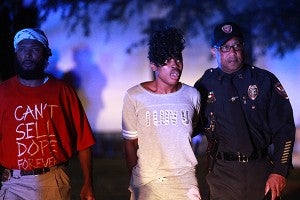 Vicksburg police investigator Dewayne Smith, left, and chief Walter Armstrong, right, escort Kourtney Wallace from her home at 323 Bayou Boulevard early Friday morning after being arrested. A joint operation called "Operation Long Time Coming," spearheaded by VPD and the Mississippi Bureau of Narcotics, culminated in 18 arrests. (Justin Sellers/The Vicksburg Post)