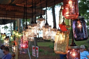 Mason jar lights adorn the "Mason Jar Junkies" tent Saturday during Lake Fest at Eagle Lake. (Justin Sellers/The Vicksburg Post)
