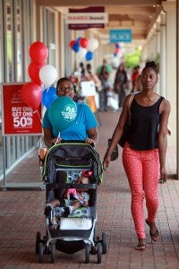 Courtney Davis, from left, Ariel Davis, 9 months, and Verna Thomas shop Saturday during the 20th anniversary celebration at the Outlets at Vicksburg. (Justin Sellers/The Vicksburg Post)
