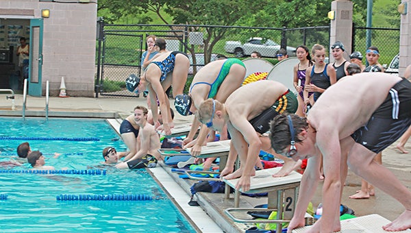 Vicksburg Swim Association members, from left, Adrienne Eckstein, Ann Elizabeth Farthing, Adam Eckstein and Matthew Copes prepare to jump off the starting block during practice Wednesday morning at City Pool. They’ll compete in the Stamm Family Invitational meet there this weekend. (Alexander Swatson/The Vicksburg Post)