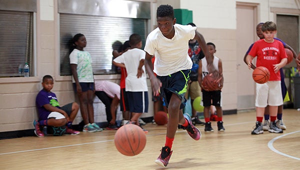 Keshawn Brown chases down a ball during a drill Monday at the Play 2 Wynn basketball camp in the Vicksburg JROTC building.