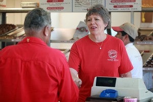 Shipley Donuts owner Becky Yelverton serves a customer Thursday morning at the Halls Ferry donut shop. (Justin Sellers/The Vicksburg Post)