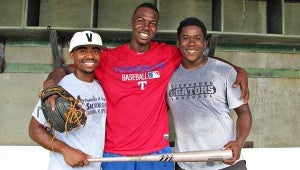 Clyde Kendrick, center, poses with his friends Marcus Williams, left and Jekori Reed in the dugout at Bazinsky Field. Kendrick, a former Vicksburg High star, was selected by the Texas Rangers in the 27th round of the Major League Baseball draft earlier this month. 