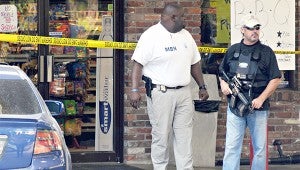 DRUG SEIZURE: Mississippi Bureau of Narcotics Agents Norman Harris, left, and Capt. Jimmy Nichols stand outside the Pecan Ridge Shell at 20 Freetown Road in 2011 after a drug bust yielded hundreds of packages of the illegal drug called spice.