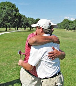 Parker Rutherford, right, hugs his father Chris Rutherford after winning the Warren County Championship Sunday at Clear Creek Golf Course. (Ernest Bowker/The Vicksburg Post)