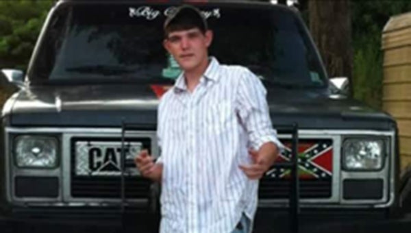 Michael Collins stands with one of his most prized possessions, his truck. The body of Collins, who has been missing for 11 days after the dump truck he was driving went into the Mississippi River, has been recovered.